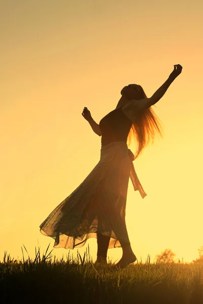 Woman\'s Silhouette Dancing at Sunset