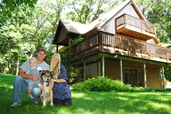 Happy Family and Dog by House