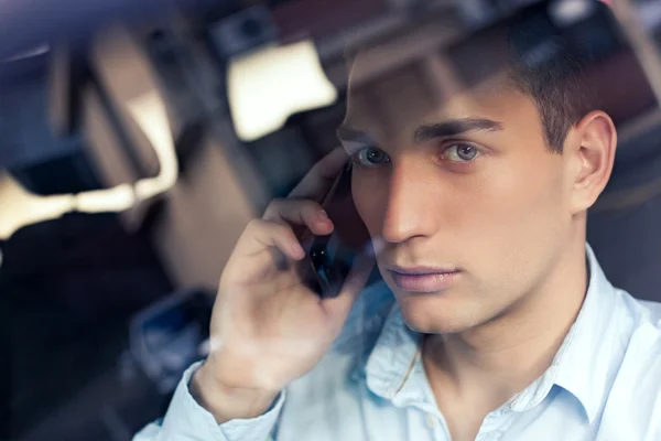 Man Telephoning in his Car