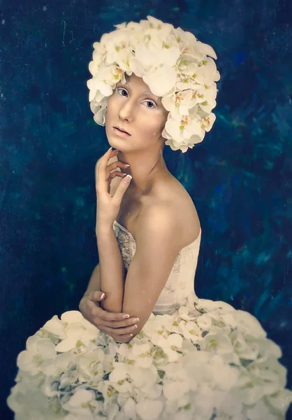 Beautiful lady with artistic visage and white flower dress