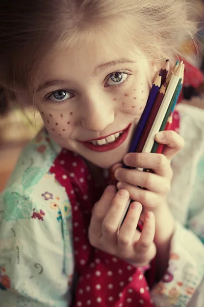 Funny girl holding pencils
