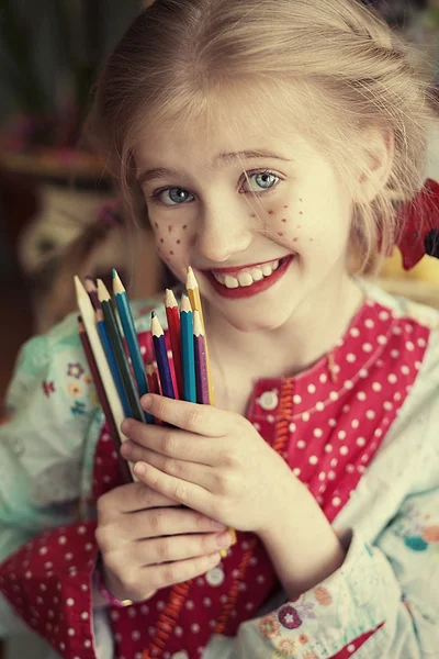 Funny girl holding pencils