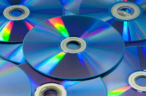 Colorful compact discs set of DVD scattered on a table
