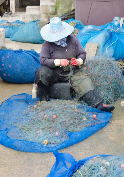 Fisherman take fish out of a net