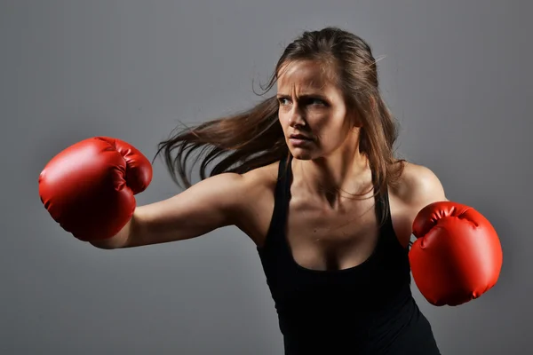 Beautiful fitness woman with the red boxing gloves