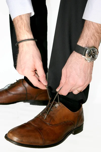 Man with elegant dress that lace up shoes