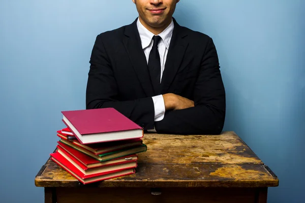 Young lawyer with stack of books