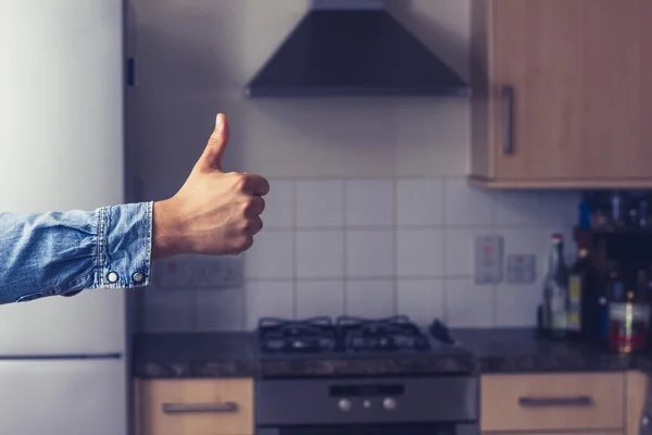 Thumbs up in clean and tidy kitchen