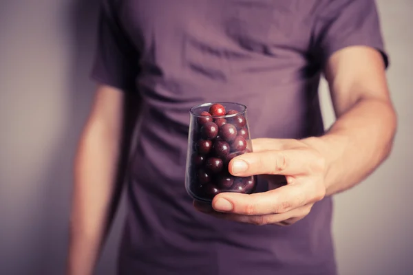 Man getting purple candy from jar