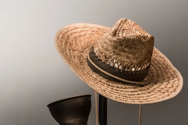 The straw stetson hat on the lamp