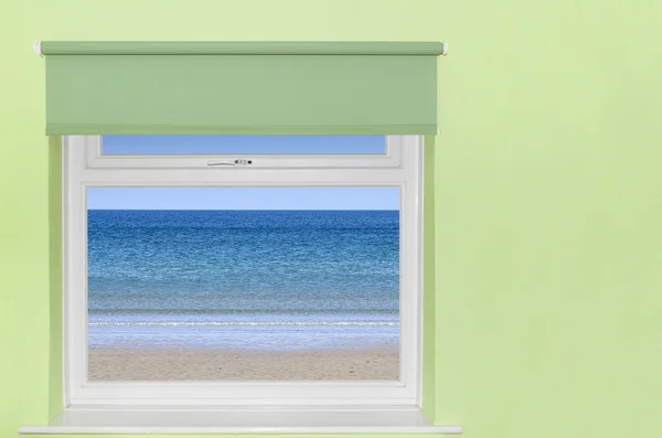 View of blue sky and beach from window