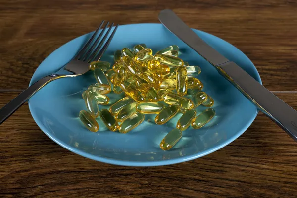 Weight loss concept close up of diet pills on plate