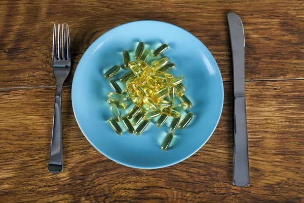 Weight loss concept diet pills on plate top view