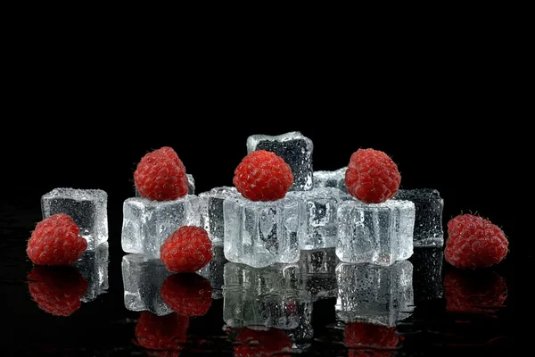 Ice cubes with raspberries — Stock Photo #27674987