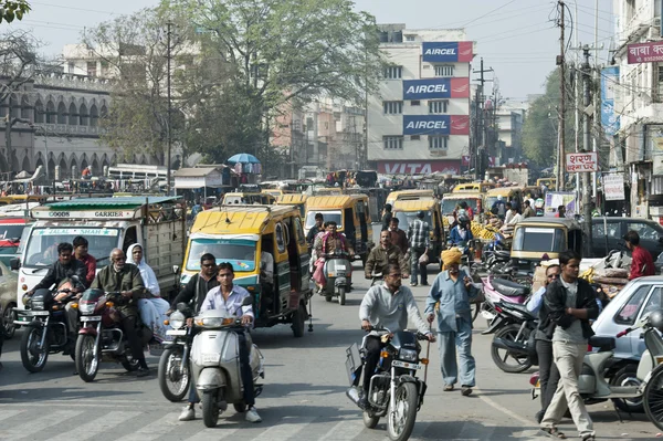 Traffic of people, cars and motorbikes in the street of New Delhi, India. one morning during my travel in india. a lot of people moving walking in the street everywhere.