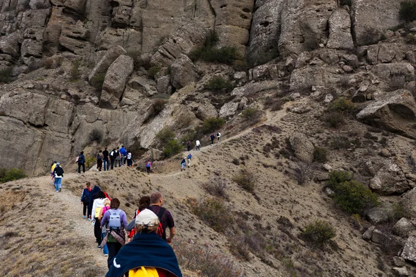 A group of tourists climb into the mountains