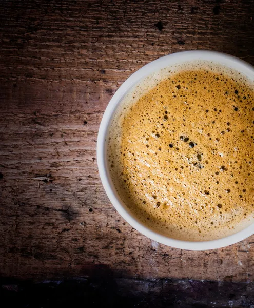 Closeup cup of espresso on old wooden table