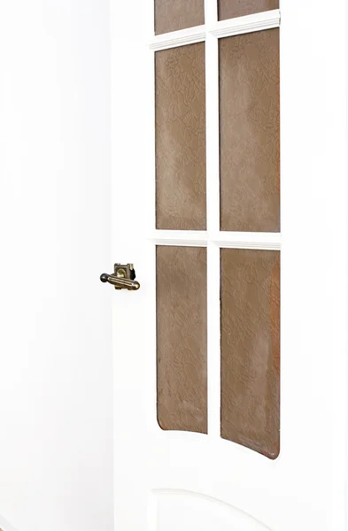 Vintage door handle on white door.