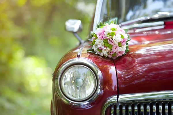 Wedding bouquet on vintage wedding car