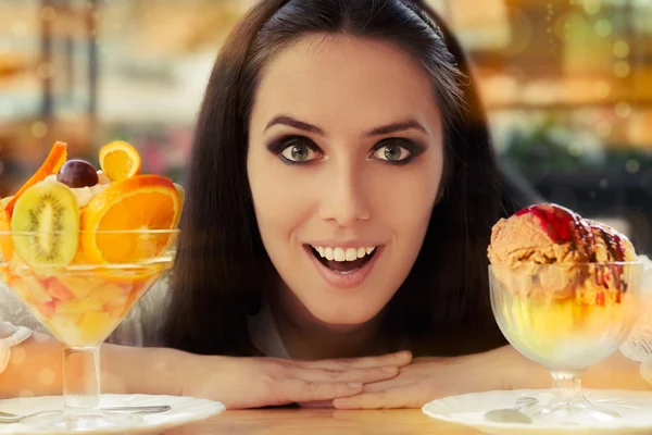 Young Woman Choosing Between Fruit Salad and Ice Cream Desserts