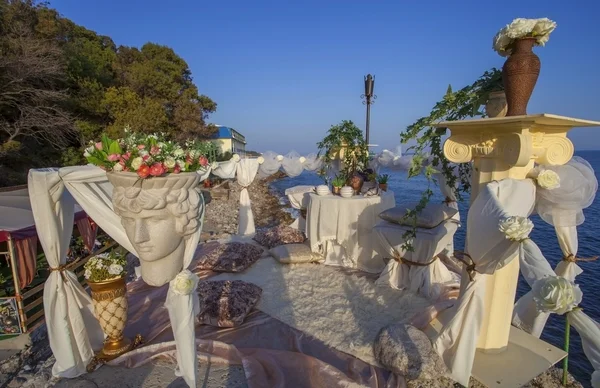 Romantic decoration of table for two on the sea shore.