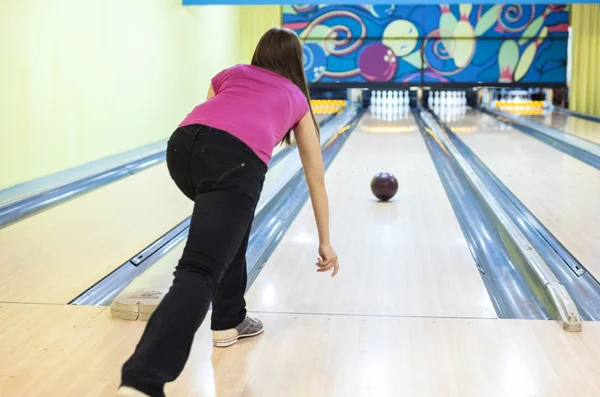 Person In Bowling Center Throws The Ball on Lane