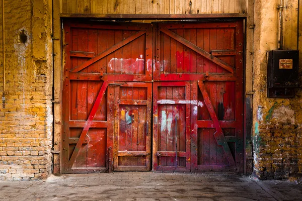 Old red wood gate in industrial interior