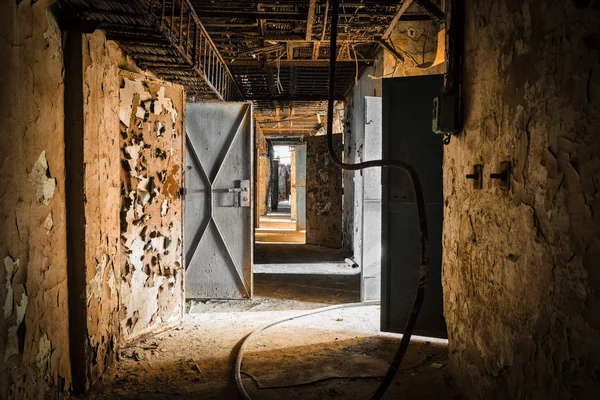Abandoned old workplace corridor with open doors