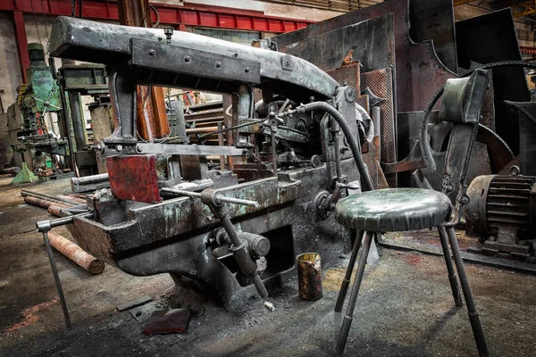 Old industrial metal sawing machine to a repair shop