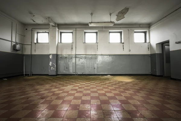 Old empty room, checkered tile floor