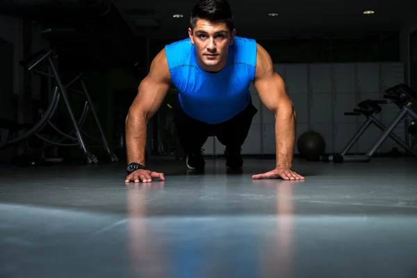 Healthy young guy doing push up exercise