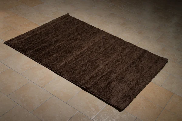 Single Brown Carpet Folded On Floor