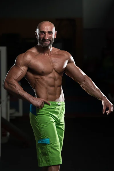 Mature Muscular Man Flexing Muscles