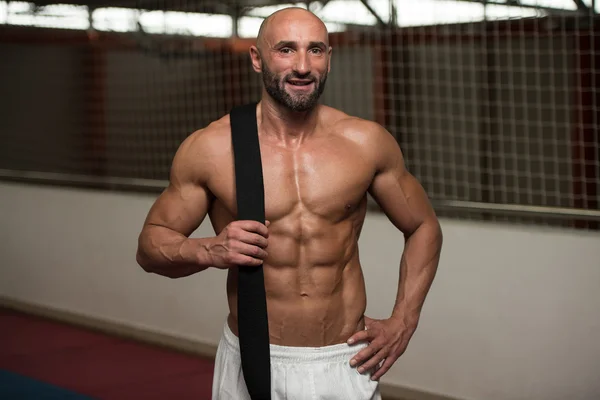 Sexy Muscular Man With Black Belt On Shoulder