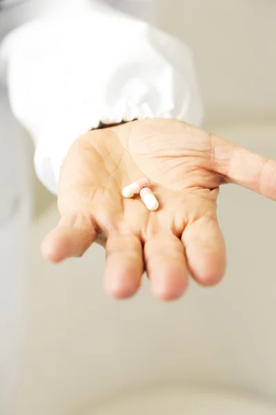 Doctor holding pills against anxiety