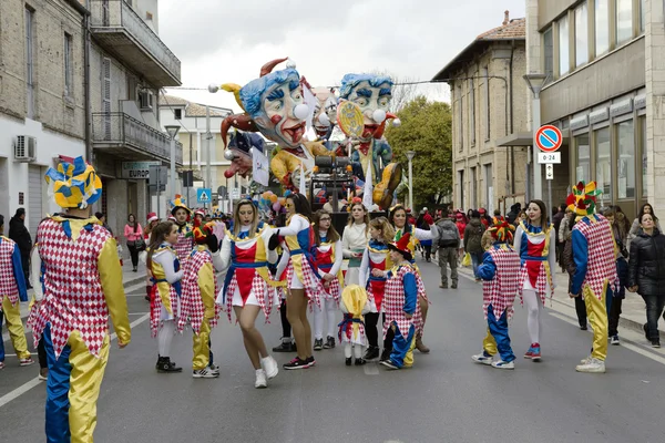 S.Egidio, Italy - March 2, 2014: Floats and happy masked people walking the streets of Sant\'Egidi