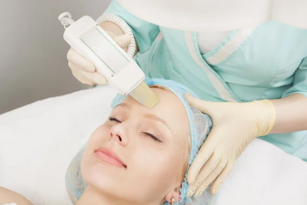 Girl in a beauty salon has a professional cleaning skin