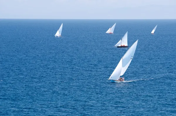 Sailing regatta, regatta in the sea.Start of a sailing regatta.The sailing yachts in speed,white yachts in a sea,Sardinia,Italy,active sport,regatta photo with the space for text.Proffesionals sailors