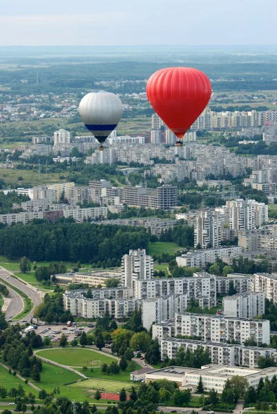 Vilnius city from the top, view to the new suburbs, Europe, Vilnius, Lithuania. Vilnius city view. Vilnius city view with flying balloons background.Two balloons flying in the air.Summer activities