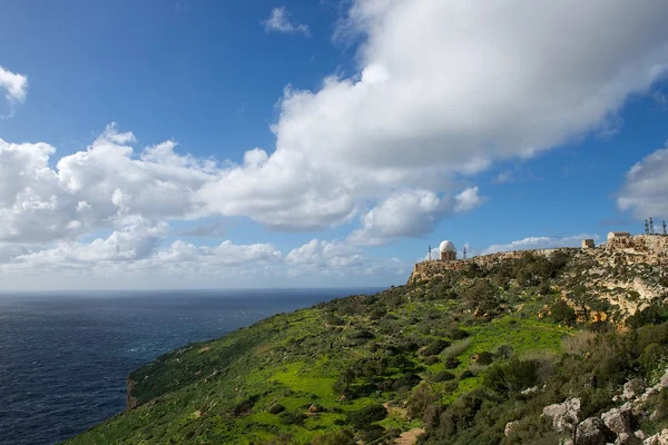 Beautiful mountains view with nice cloudy sky on sunny summer day in Malta, road to the rock with blue sky background, maltese landscape, maltese nature, hiking in mountains in Malta, Dingli cliffs