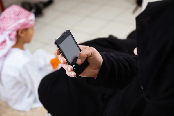 Arabic mother using smart phone