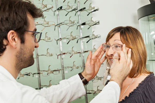 Woman With Ophthalmologist Examining Eyeglasses
