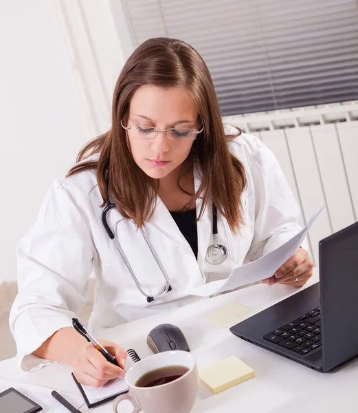 Female doctor working in office