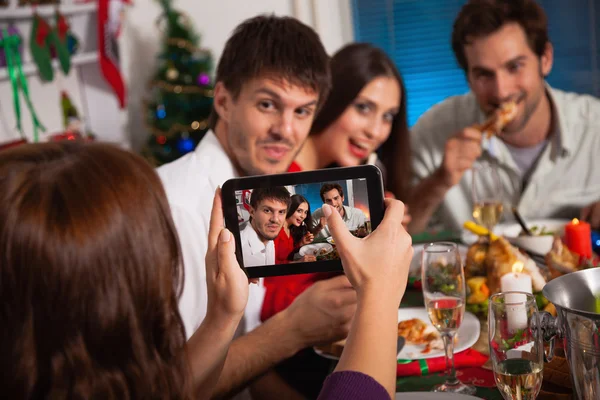 Friends taking picture on Christmas eve