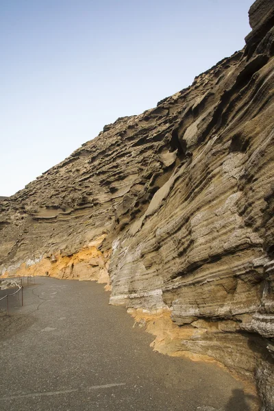 Sandstone twisted into waves by volcanic activity. Structure rev