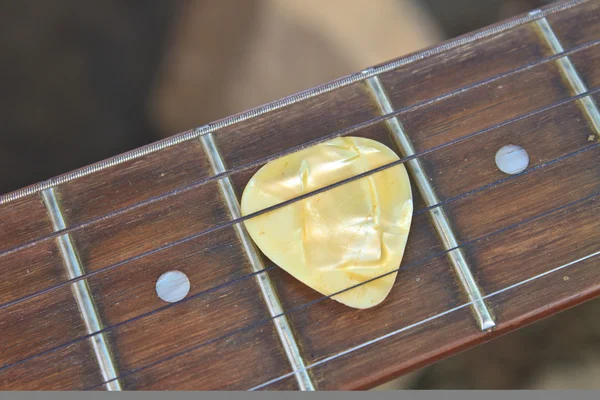 Guitar pick on the fingerboard