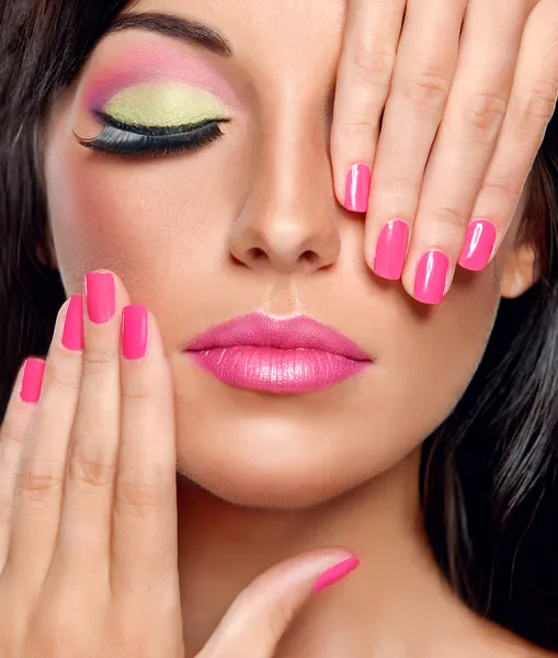 Brunette woman with modern make-up and manicure