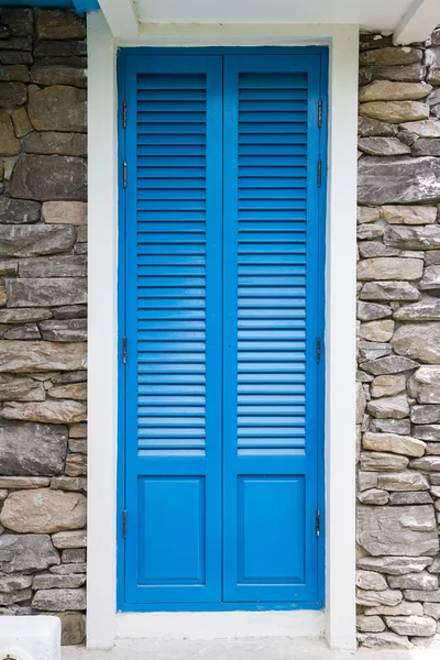Blue wooden window with stone decorate