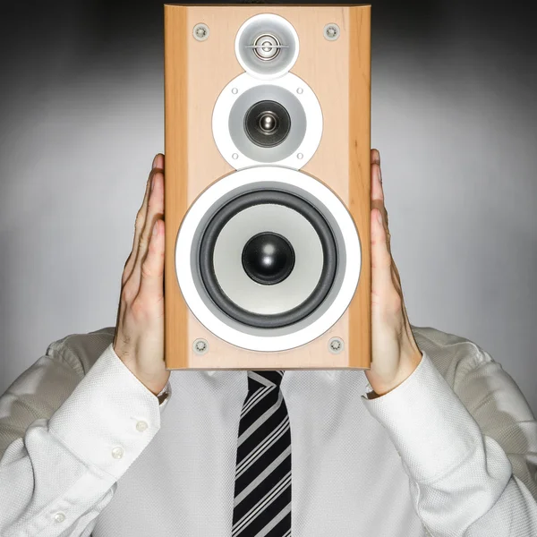 Man with speaker in front of face