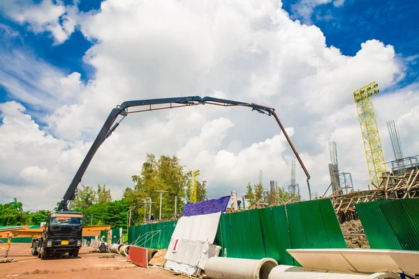 Building under construction with workers and crane car